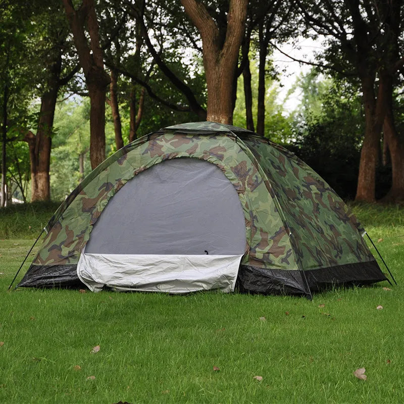Green camouflage dome tent with mesh windows and steel ground nails setup outdoors