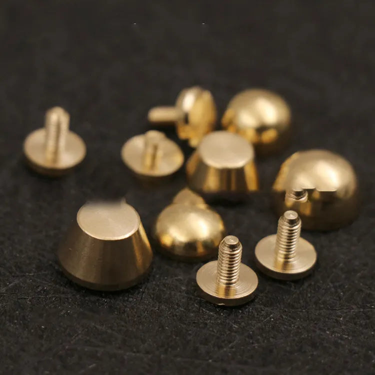 Assortment of brass decorative buckles in antique gold finish showing round foot nail and bucket foot nail designs