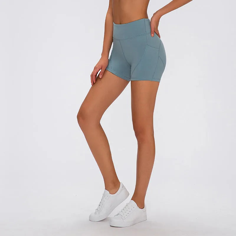 SHINBENE women's high waisted athletic shorts in black with two side pockets and cotton feel nylon spandex fabric