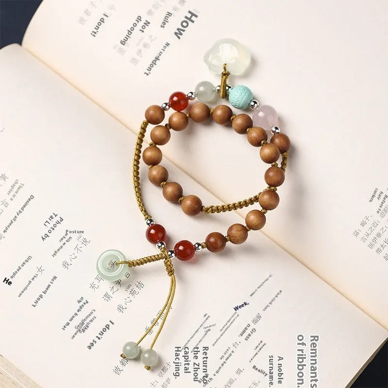 Hand-woven ebony bracelet with double ring design and traditional ruyi elements