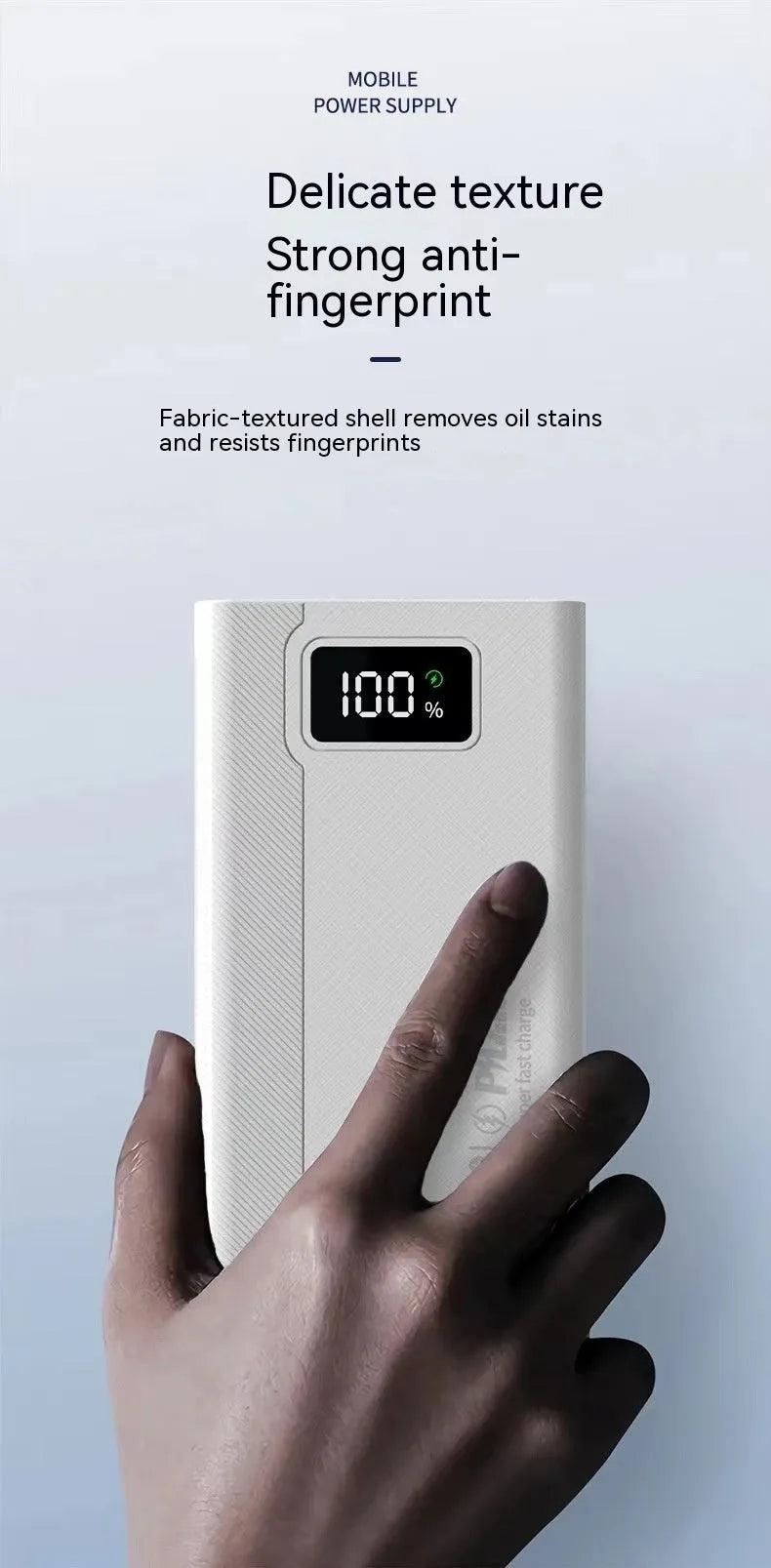 Black and white large capacity portable power bank with fast charging, showing size scale.