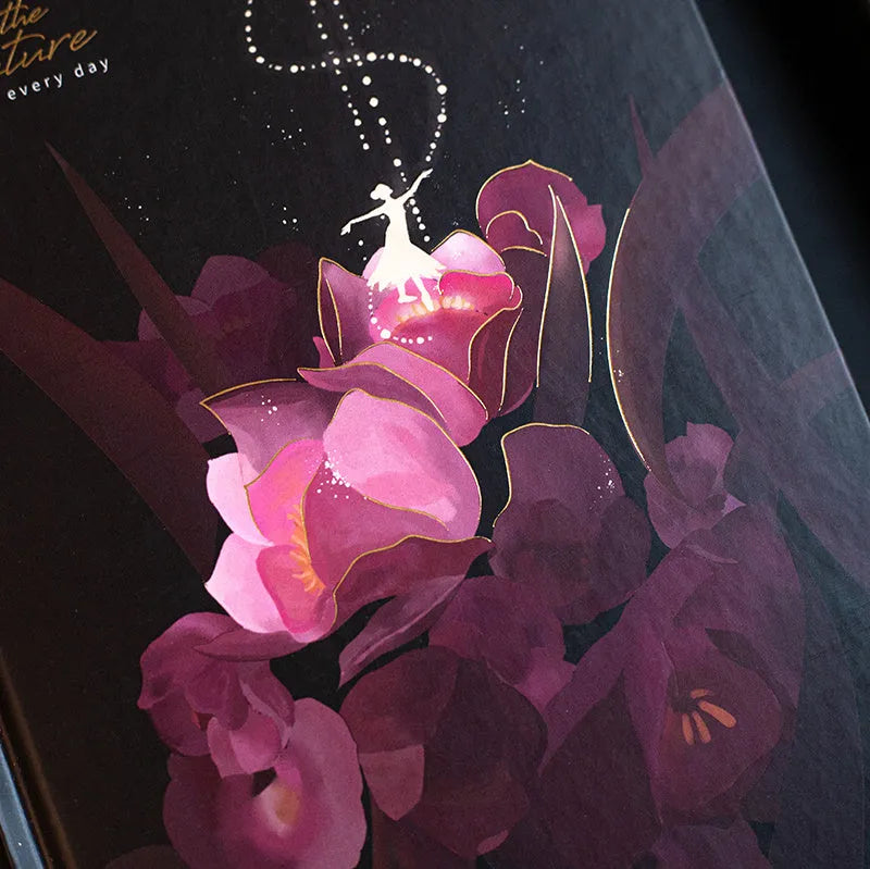 A5 notebook with a luminous blue cover, open to show white paper and a colour illustration page.