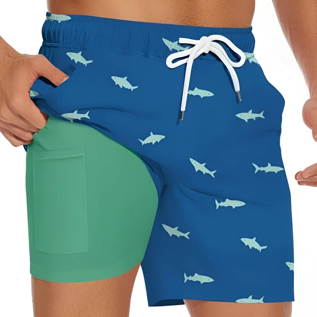 Men's black casual shorts with a white shark graphic print and a white drawstring waistband.