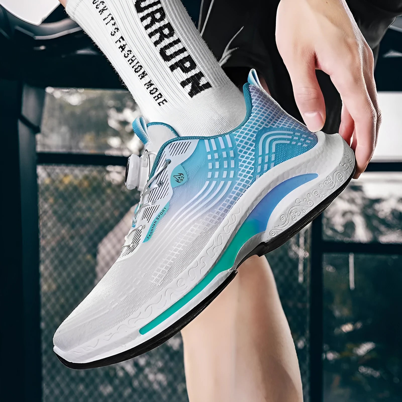Men's white and blue mesh sneaker with a rotating buckle closure and rubber sole.