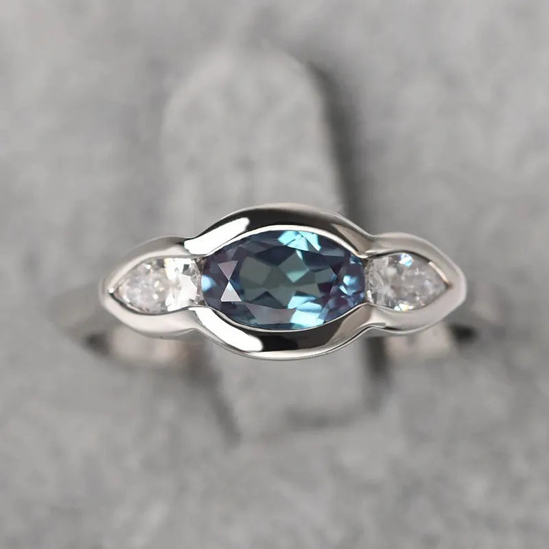 Geometric ellipse women's ring with zircon inlay in white gold finish, showing sizes 6 to 10