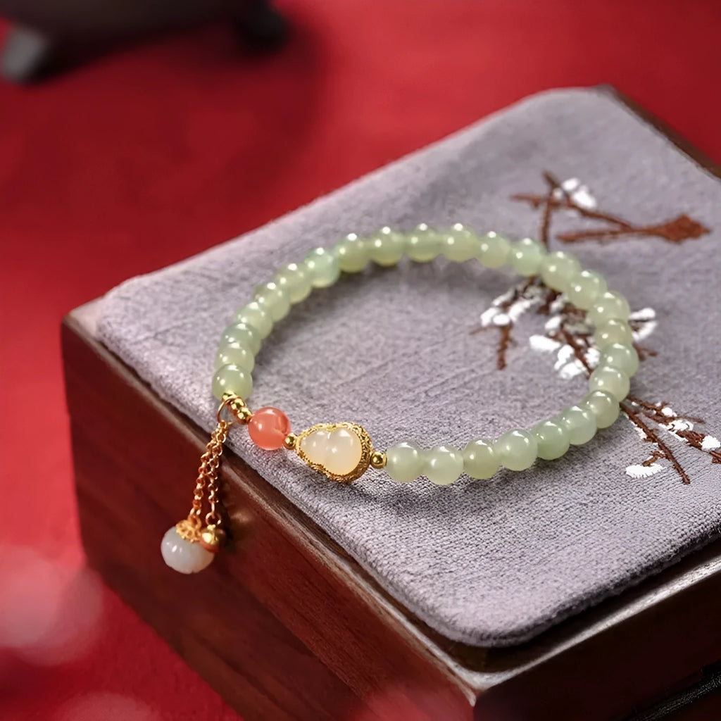 Jade women's bracelet with gold plated gourd charm and fu character decoration
