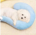 Blue U-shaped cat pillow in question mark style on a white background.
