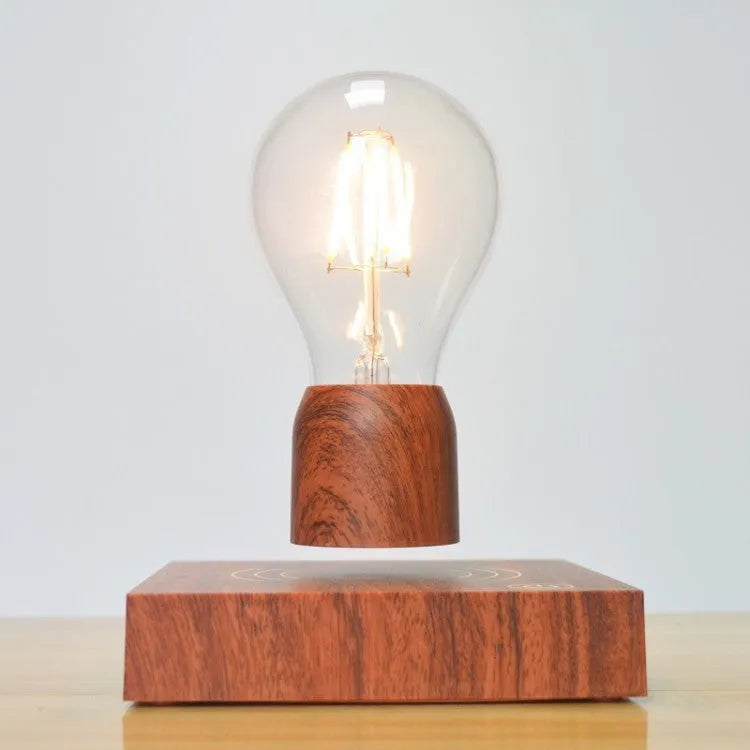 Magnetic levitation floating LED light bulb above an imitation wood base.