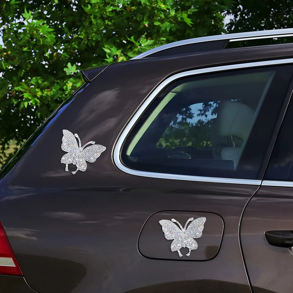 White diamond-encrusted car sticker patch showing butterfly and bear claw designs on a 7x6 cm glass base.