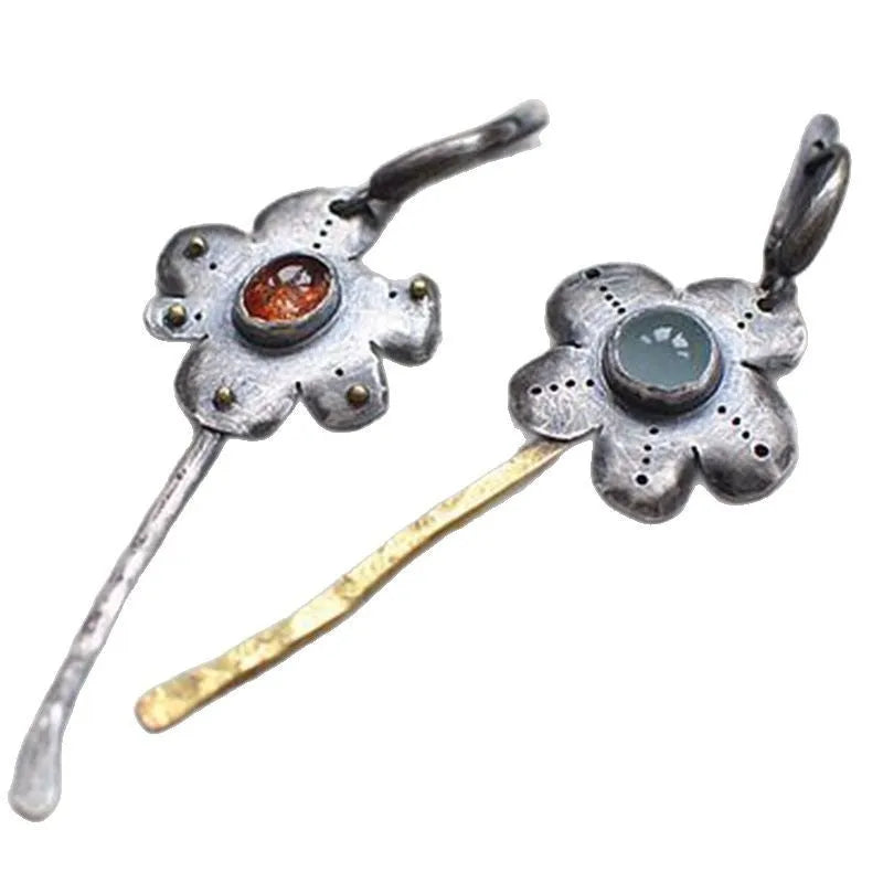 Geometric floral retro earrings with two-tone asymmetrical design and long drop style.