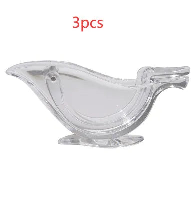 Transparent acrylic manual lemon juicer with bird-shaped design on a kitchen counter