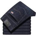 Straight leg stretch jeans in blue denim on a mid-waist model, showing zip fly and high elasticity fabric.