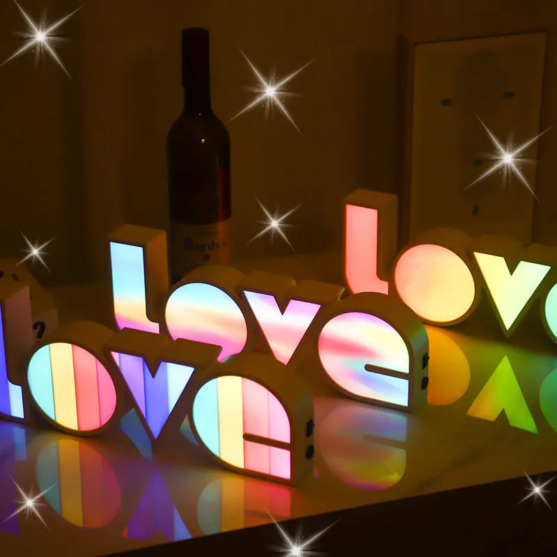 LED Love light with rainbow 'LOVE' lampshade on a table.