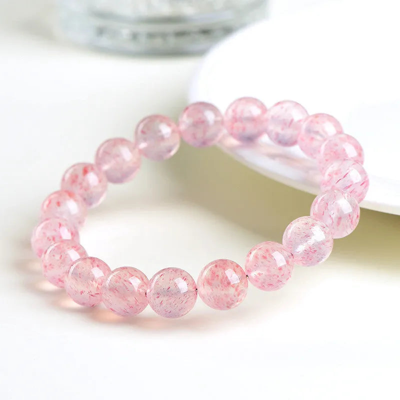 Strawberry quartz crystal bracelet with 10-10.8mm round beads in natural white water colour
