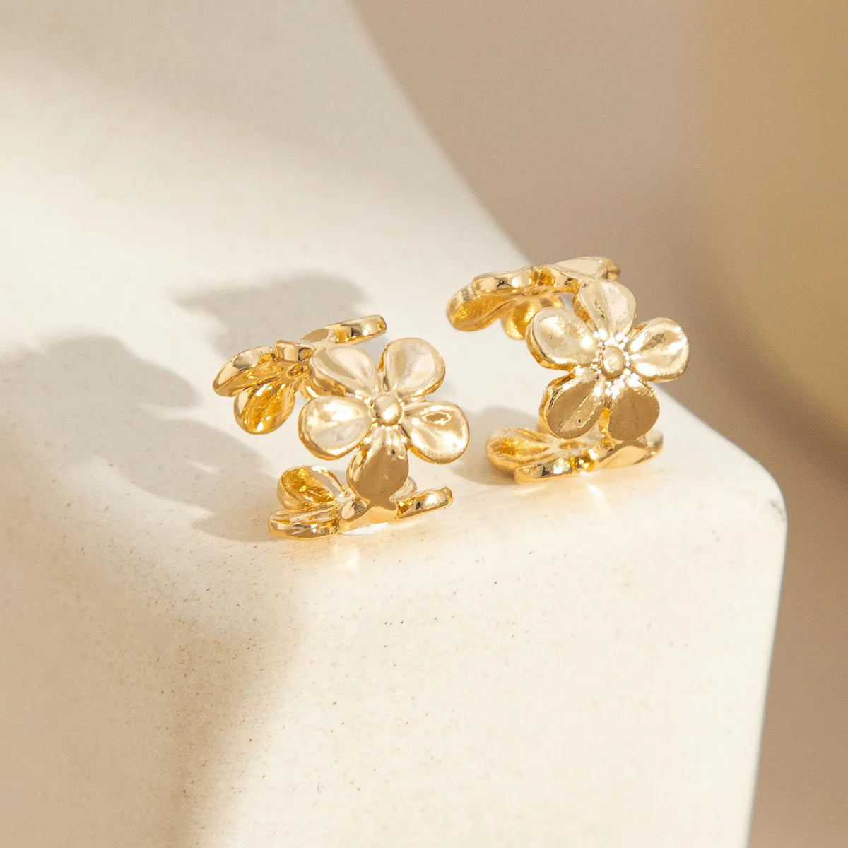 Gold starfish and conch alloy drop hoop earrings for women.