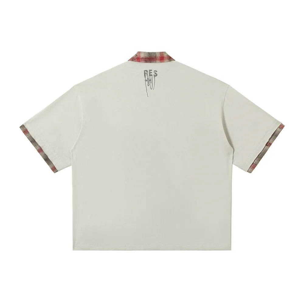 Men's loose blue cotton short-sleeved top with asymmetric lapel and graffiti print detail.