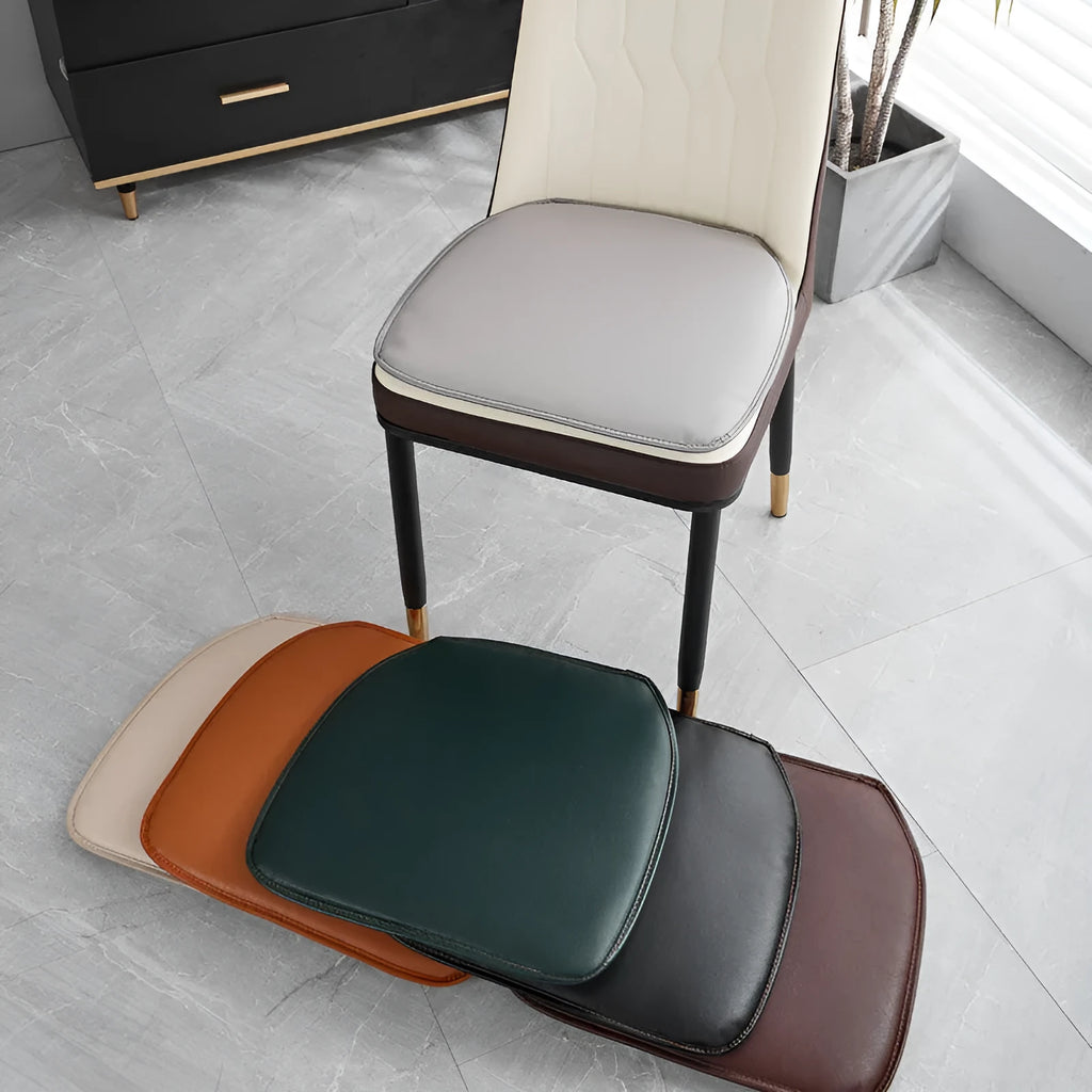 Leather horseshoe-shaped seat cushion in orange colour on dining chair