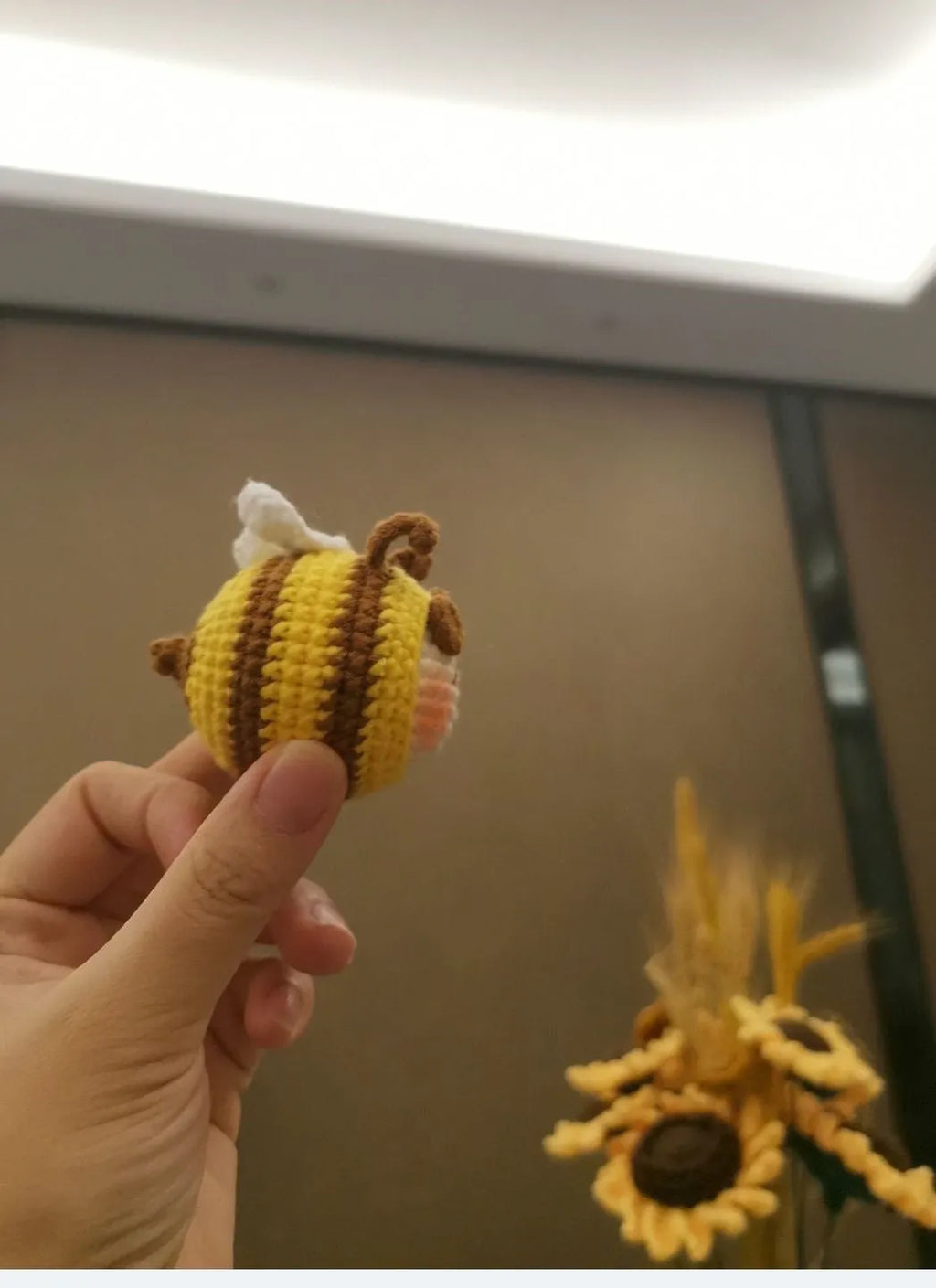 Handmade crocheted bee colony pendant accessory for a woolen doll.