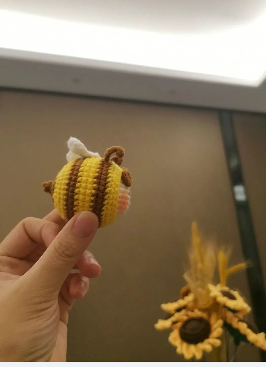 Handmade crocheted bee colony pendant accessory for a woolen doll.
