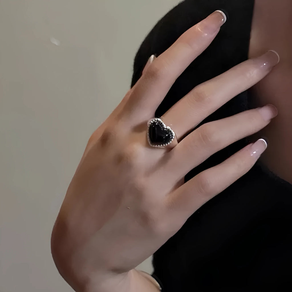Sterling silver ring with a heart-shaped black agate stone and an adjustable open mouth design.