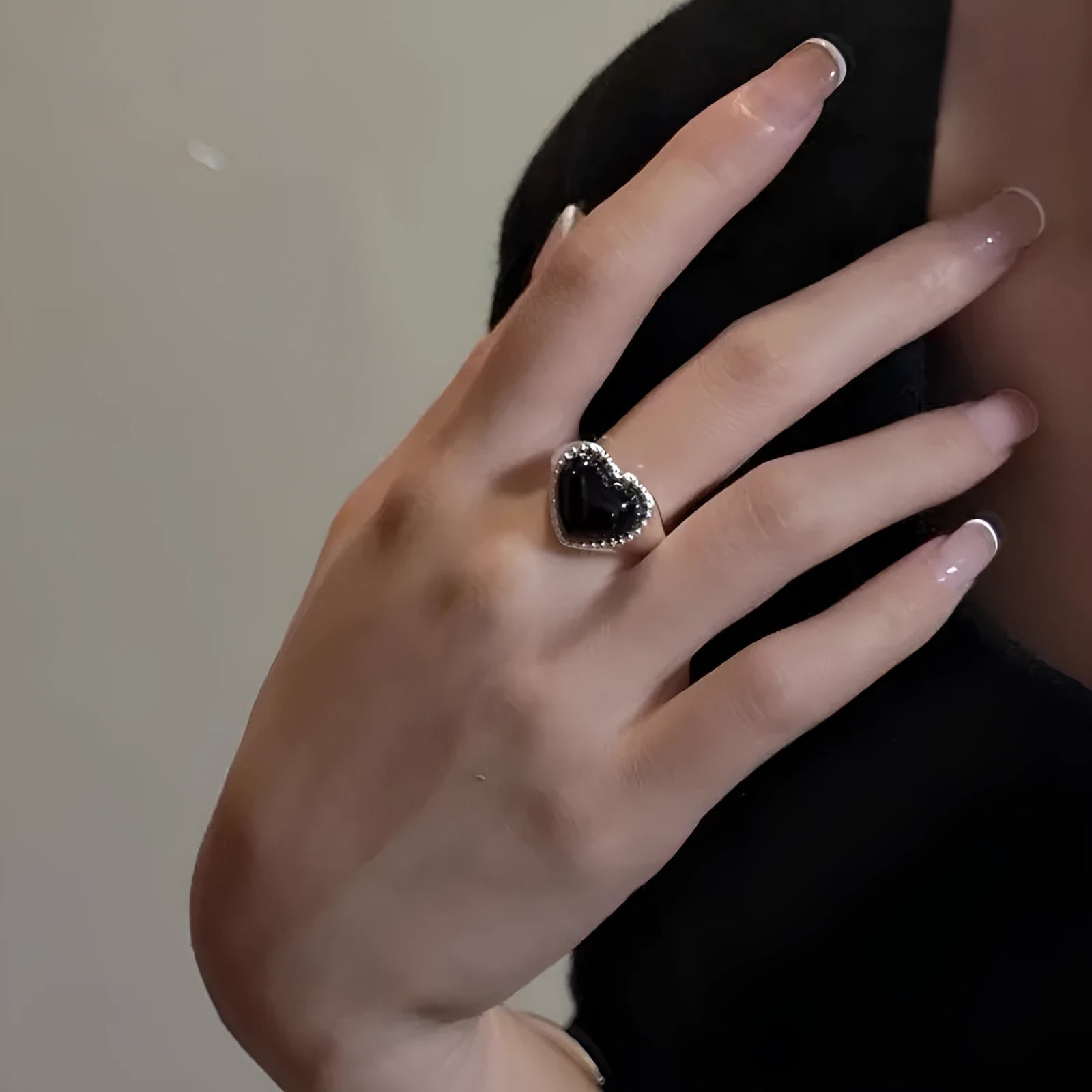 Sterling silver ring with a heart-shaped black agate stone and an adjustable open mouth design.