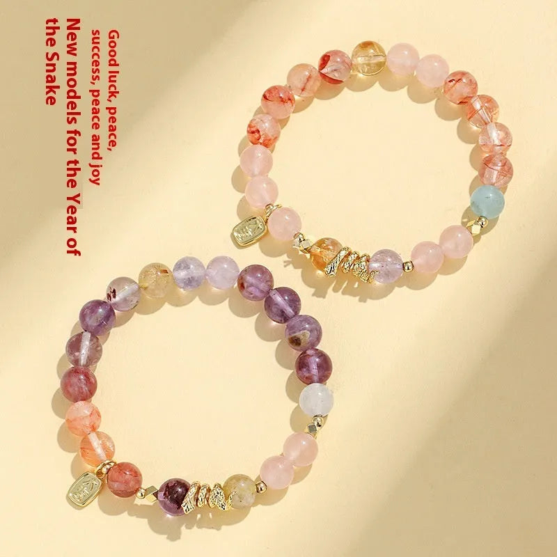 Women's crystal bracelet with lucky snake design and flower beads in amethyst colour