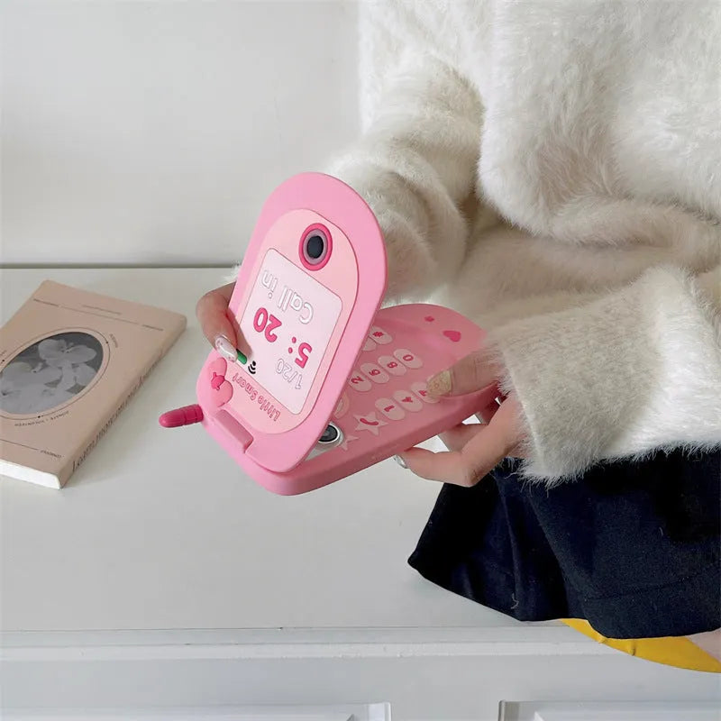 Light pink silicone iPhone case with a built-in cosmetic mirror, showing a cute cartoon design.