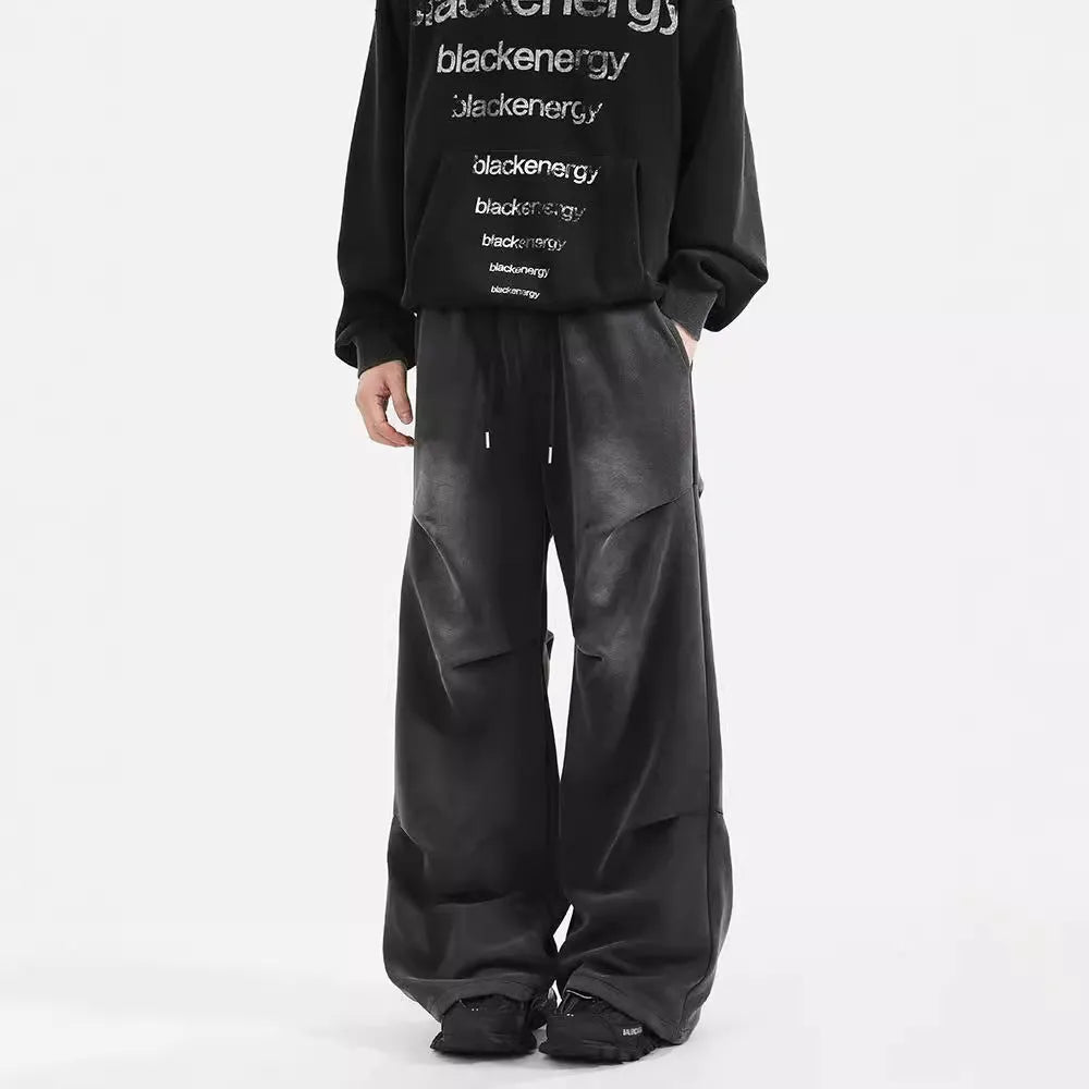 Men's pleated straight loose sweatpants in black and grey, cotton fabric, elastic waist, American washed finish.