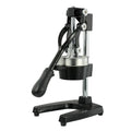 Black and white manual cast iron juicer with stainless steel funnel, 40 cm tall on kitchen counter.