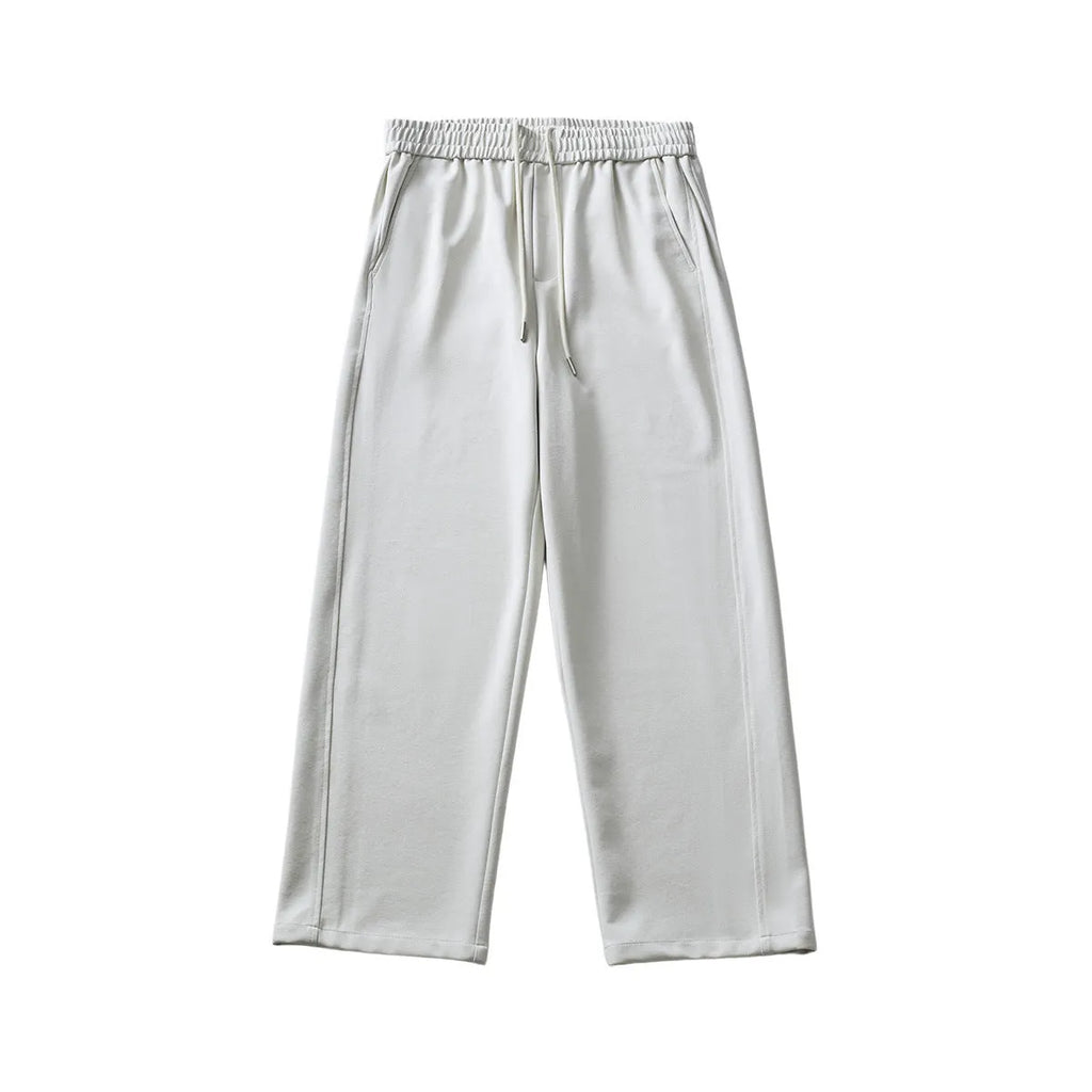 Men's grey high-waisted casual trousers with a lace-up front detail on a plain background.