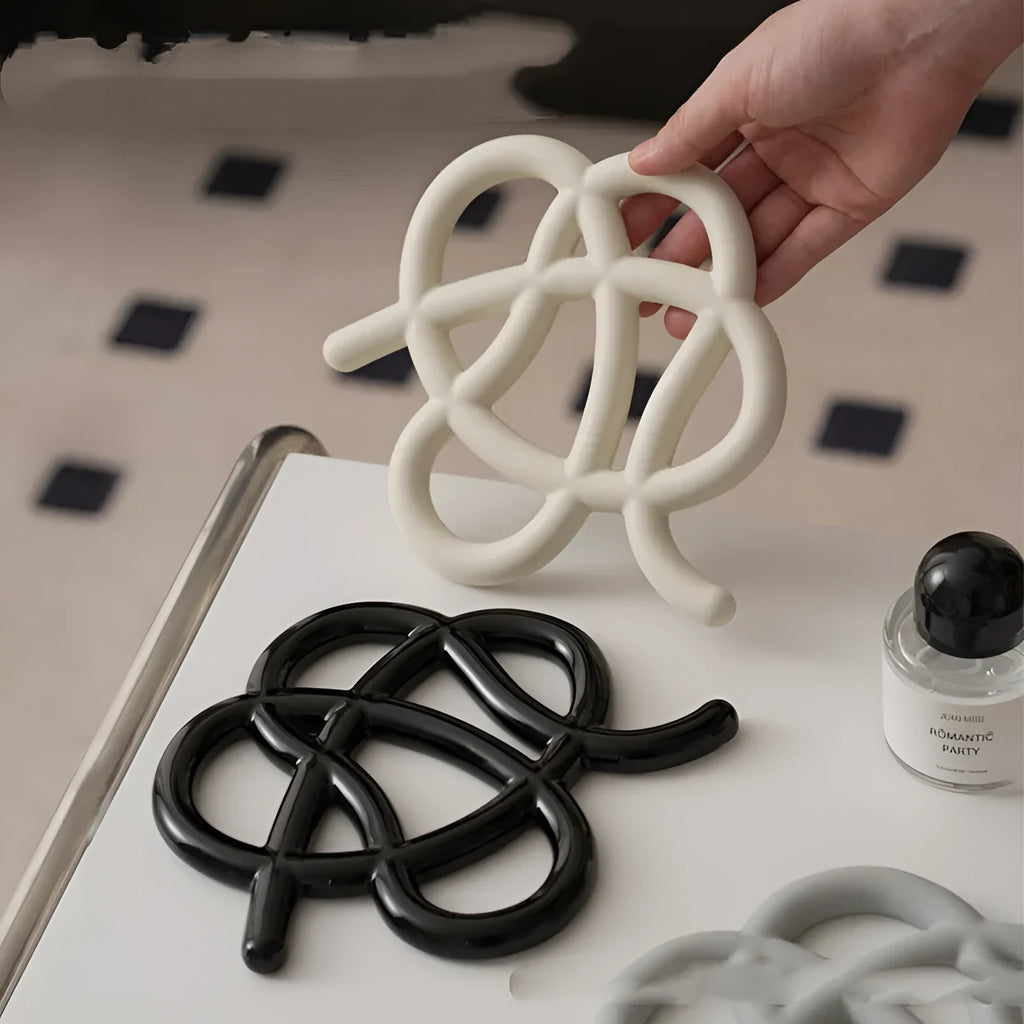 Ceramic heat-proof mat in an irregular shape on a kitchen table