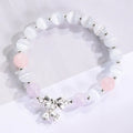 Women's opal cat's eye stone bracelet with diamond-shaped beads on wrist.