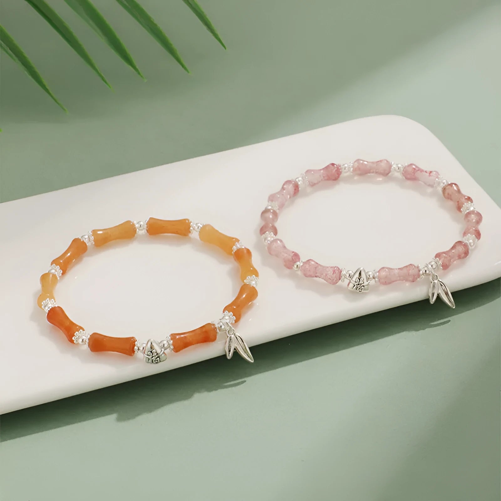 Green aventurine bamboo strawberry quartz crystal bracelet with mixed natural stones on wrist