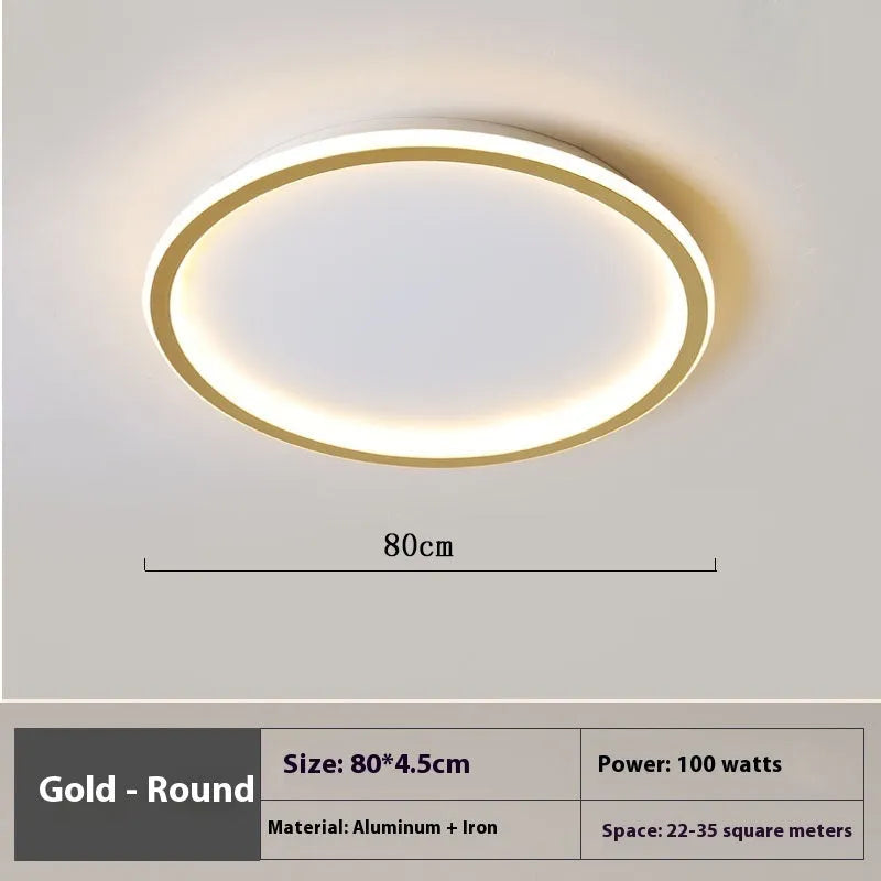 Minimalist round LED ceiling lamp in black finish with dimmable tricolour light, shown in a bedroom setting.