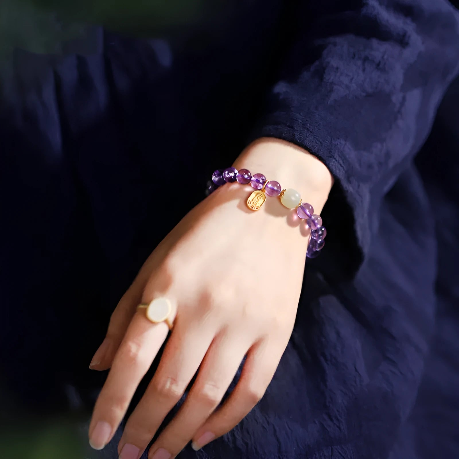 A women's bracelet with purple 8mm amethyst crystal beads arranged in a geometric, national style design.
