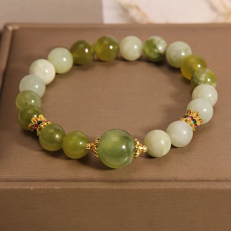 Women's solid Xiuyan jade bracelet in a green colour, shown as a single smooth bead.
