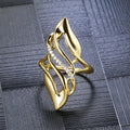 Gold-coloured copper women's ring with exaggerated curve design on finger
