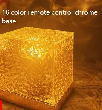 USB-powered crystal table lamp projecting blue water ripple light patterns on a wall