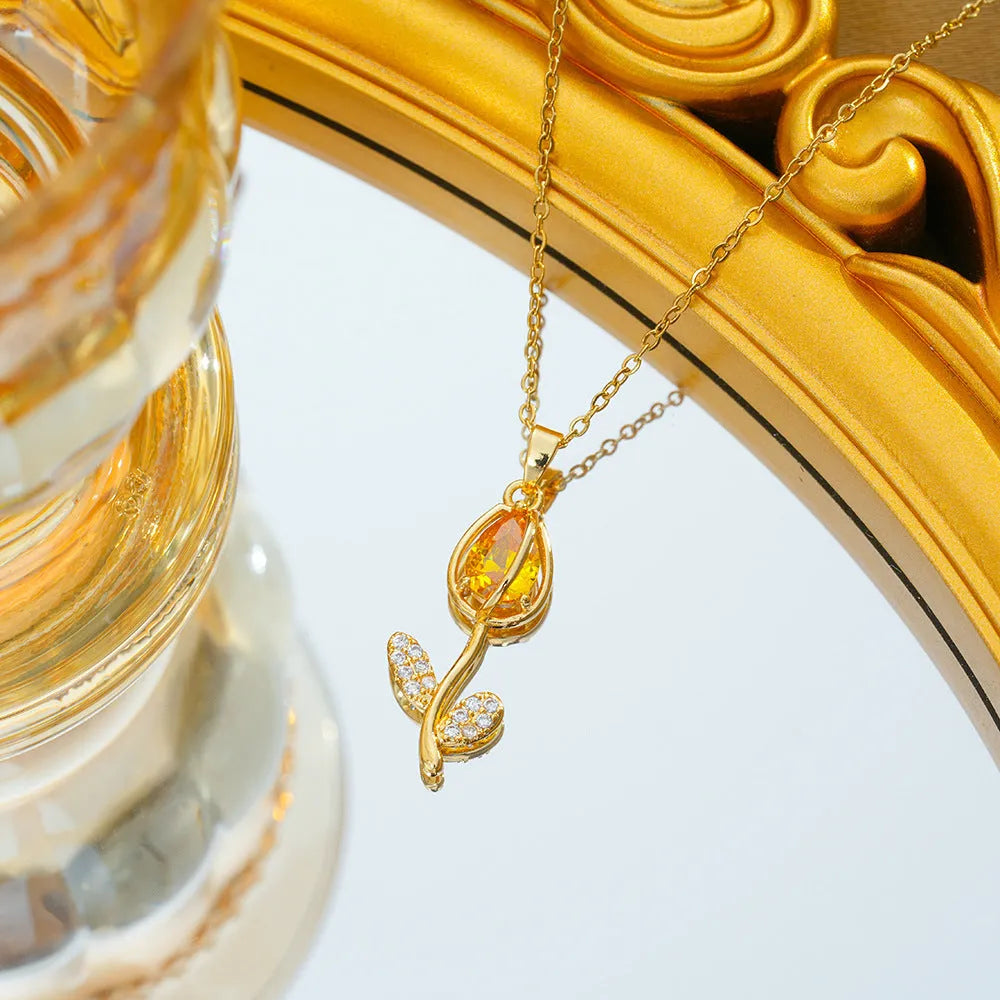 Gold-toned titanium steel necklace with a zircon tulip flower pendant on an adjustable O-ring chain.