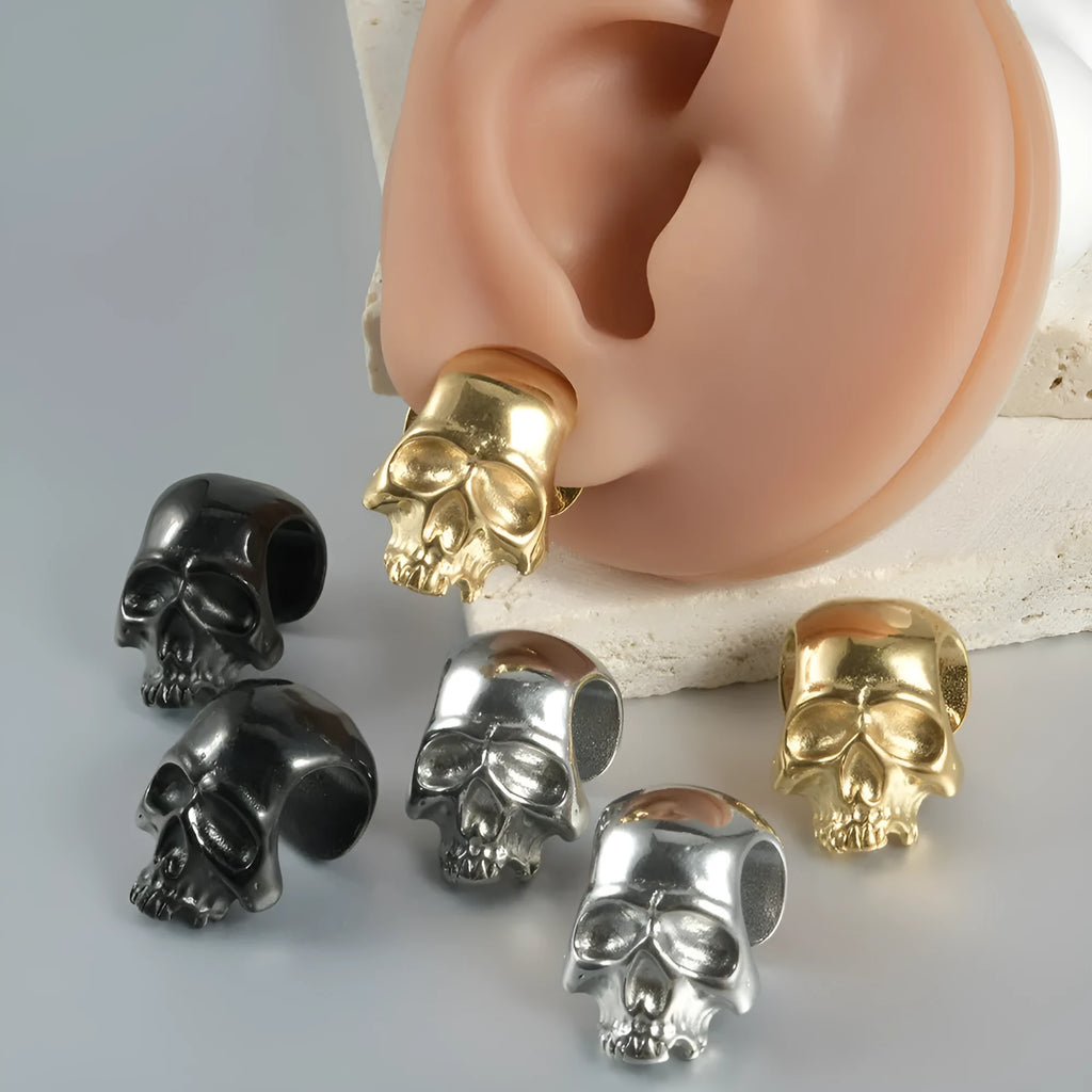 Stainless steel hollow skull Buddha earrings in hip hop style with geometric shape.