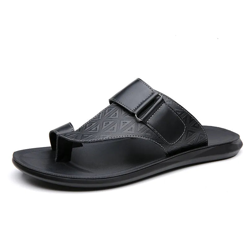 Men's white cowhide open-toe beach slippers with a rubber sole on a sandy background.