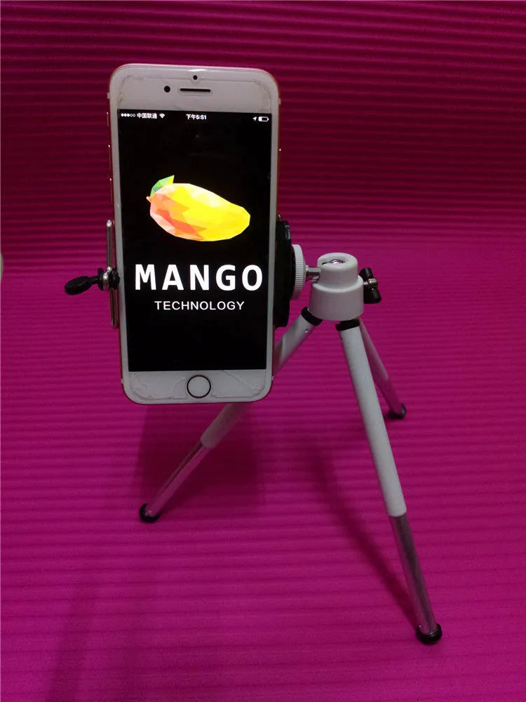 Black adjustable desktop phone holder with a two-section bracket on a wooden desk.