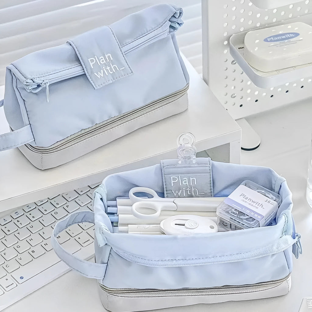 Folding double-layer student pencil case in blue polyester fabric showing internal organisation compartments.