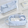 Folding double-layer student pencil case in blue polyester fabric showing internal organisation compartments.