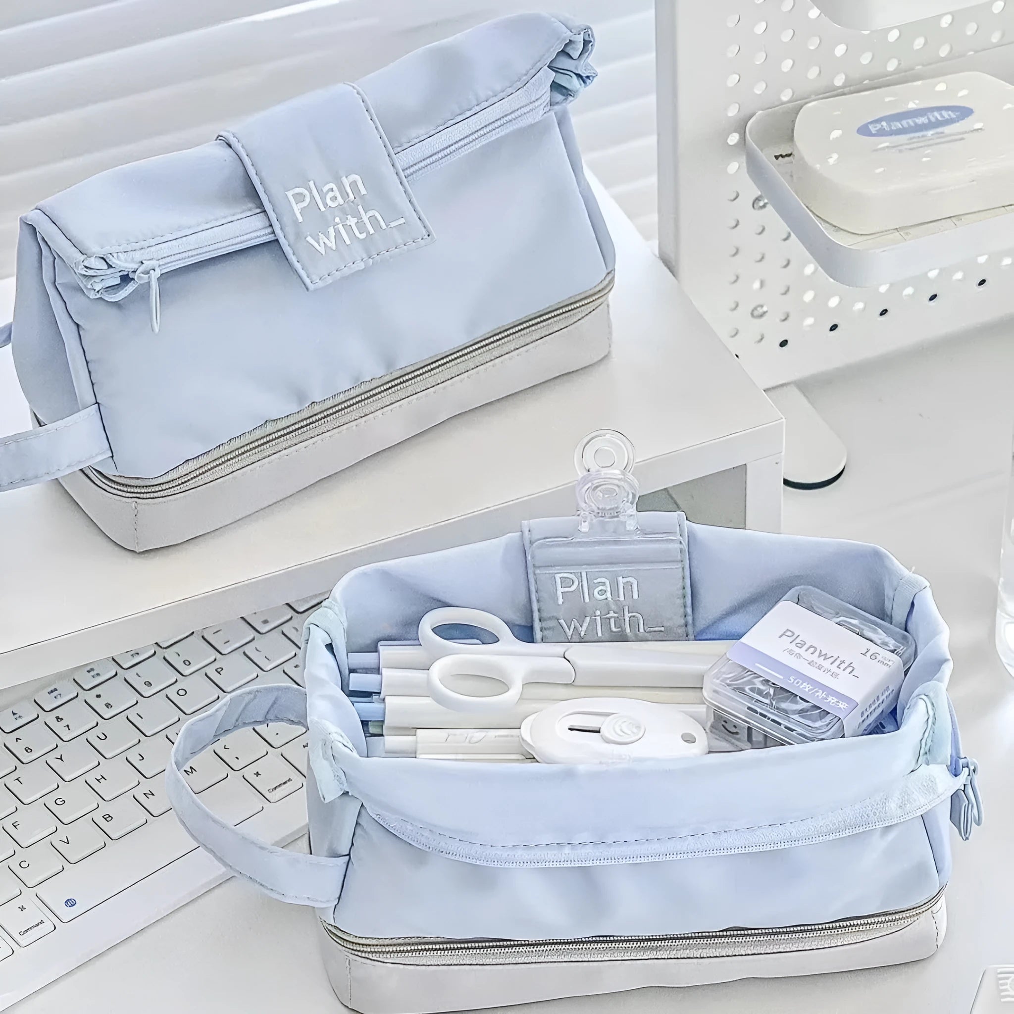 Folding double-layer student pencil case in blue polyester fabric showing internal organisation compartments.