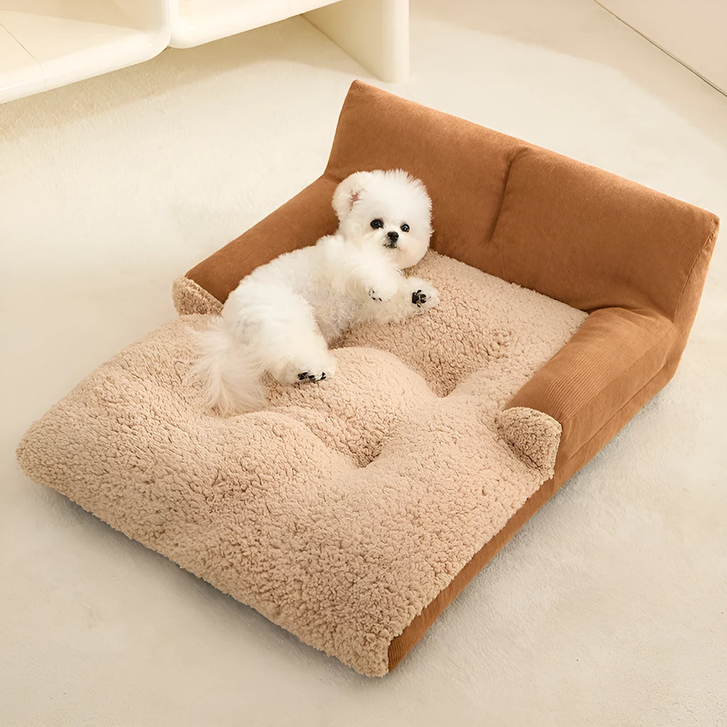 Small brown and grey fabric dog kennel bed with a plush cushion inside, showing its non-slip base.