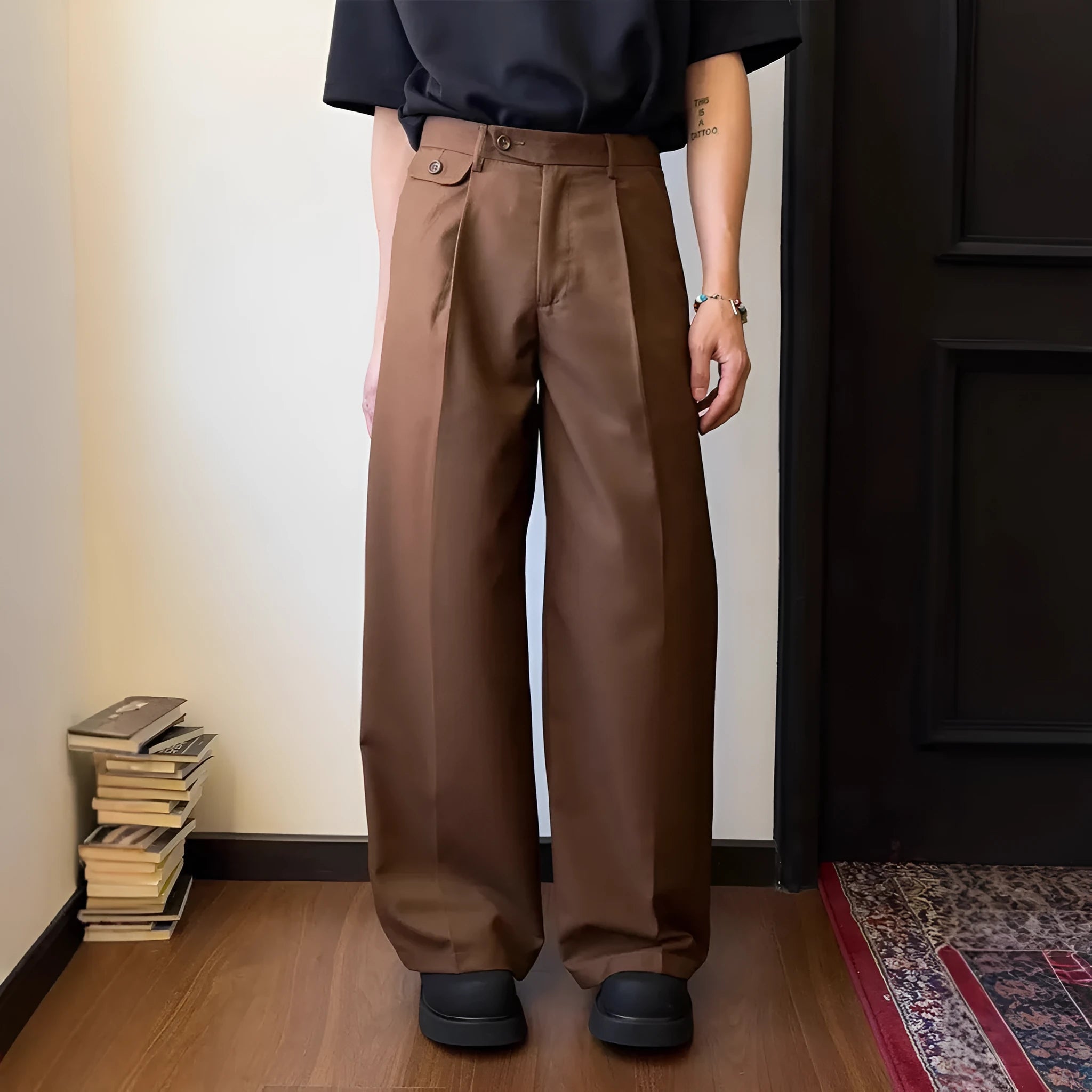 Man wearing solid colour straight-leg casual suit trousers with a loose wide-leg draping fit.
