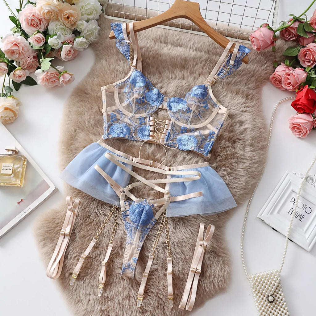 Light blue embroidered lace bra and matching briefs set on a plain background