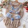 Light blue embroidered lace bra and matching briefs set on a plain background