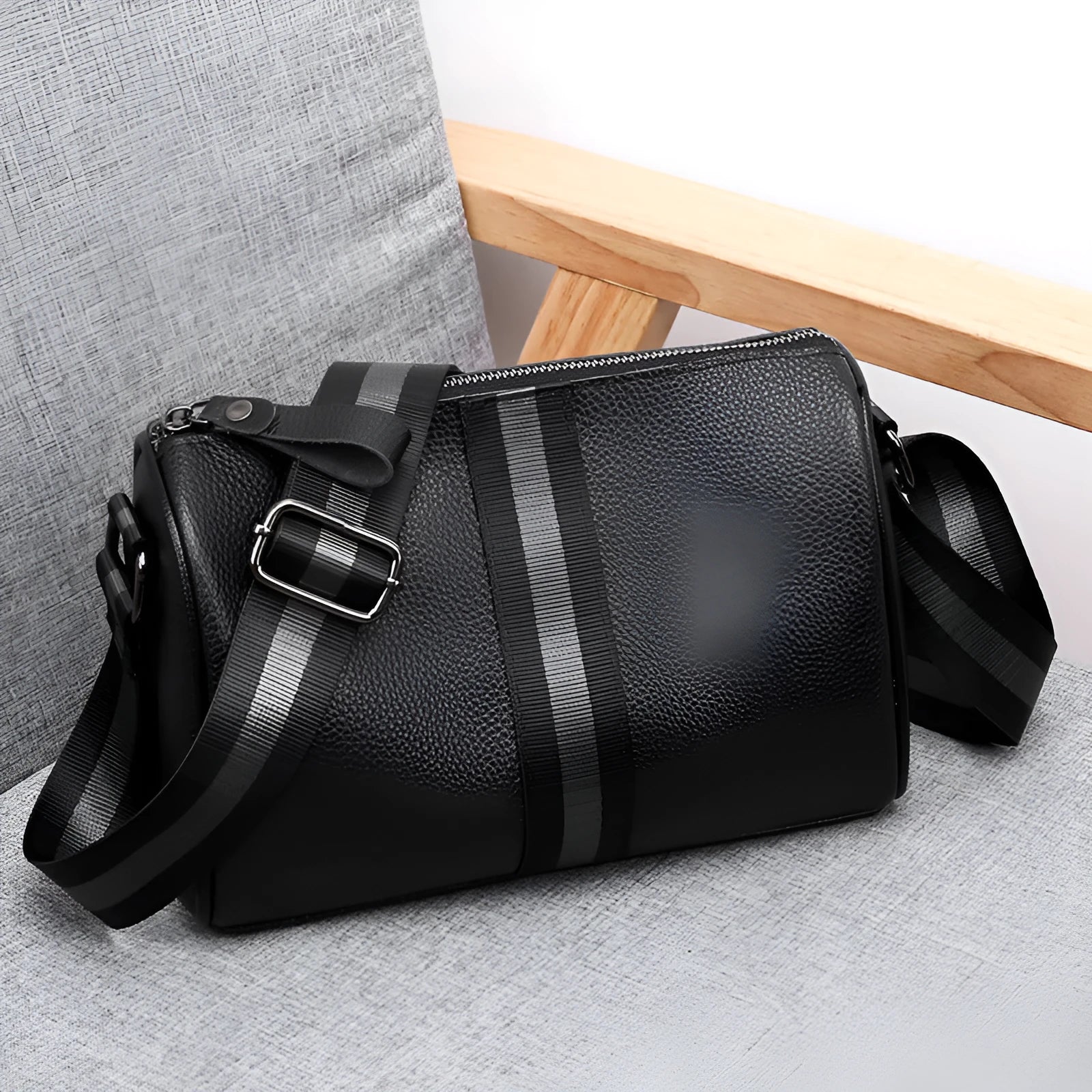 Black genuine leather one-shoulder crossbody bag showing 24cm width